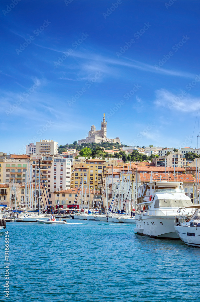 Summer view on basilica of Notre Dame de la Garde and old port in Marseille, France