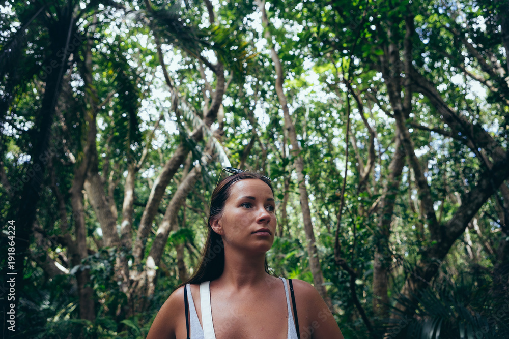 Travel lifestyle. Portrait woman traveler in dense tropical forest Travel lifestyle. Portrait woman traveler in dense tropical forest