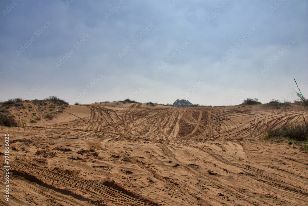 Sandy ground for cars 4x4 with traces of tires for cars wallaper