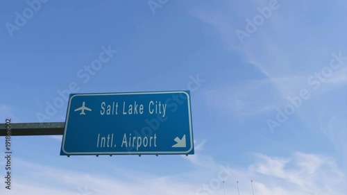 salt lake city airport sign airplane passing overhead photo