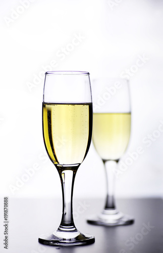 glass of white wine on a table on white background isolate