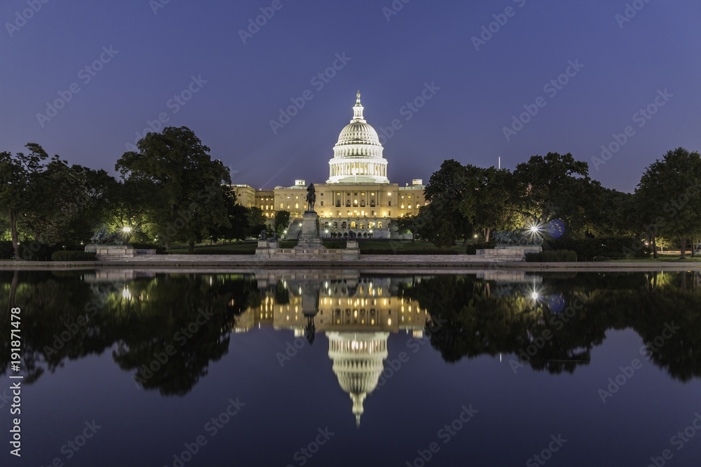The United States Capitol Building, seen from reflection pool on dusk. Washington DC, USA.