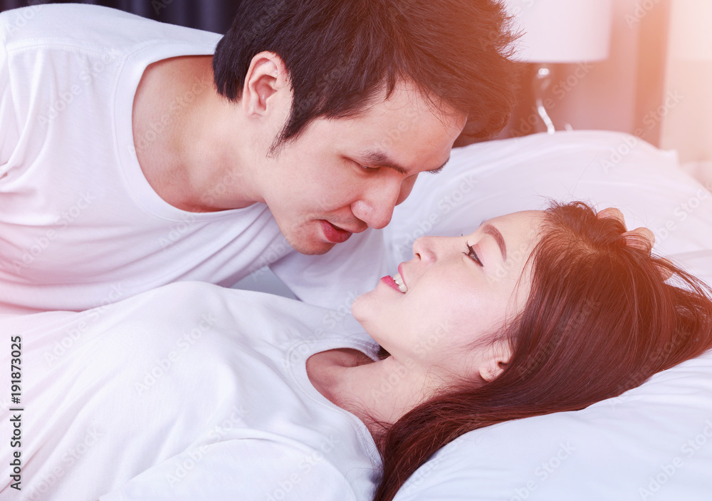 lovely couple lying in a bed and looking to each other (eyes to eyes) lovely couple lying in a bed and looking to each other (eyes to eyes)