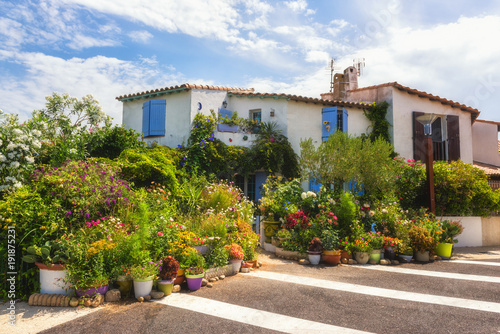Saintes-Maries-de-la-Mer, small mediterranean town,  cozy house decorated with different flowers and plants. Popular tourist destination in Camargue, Provence, France © larauhryn
