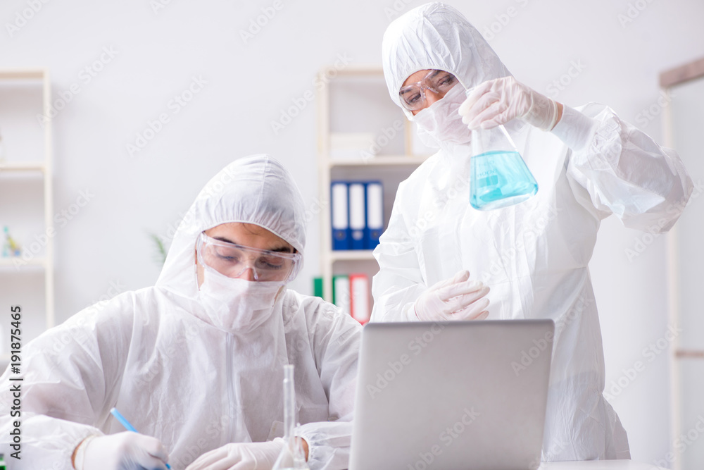 Two chemists working in the lab Two chemists working in the lab