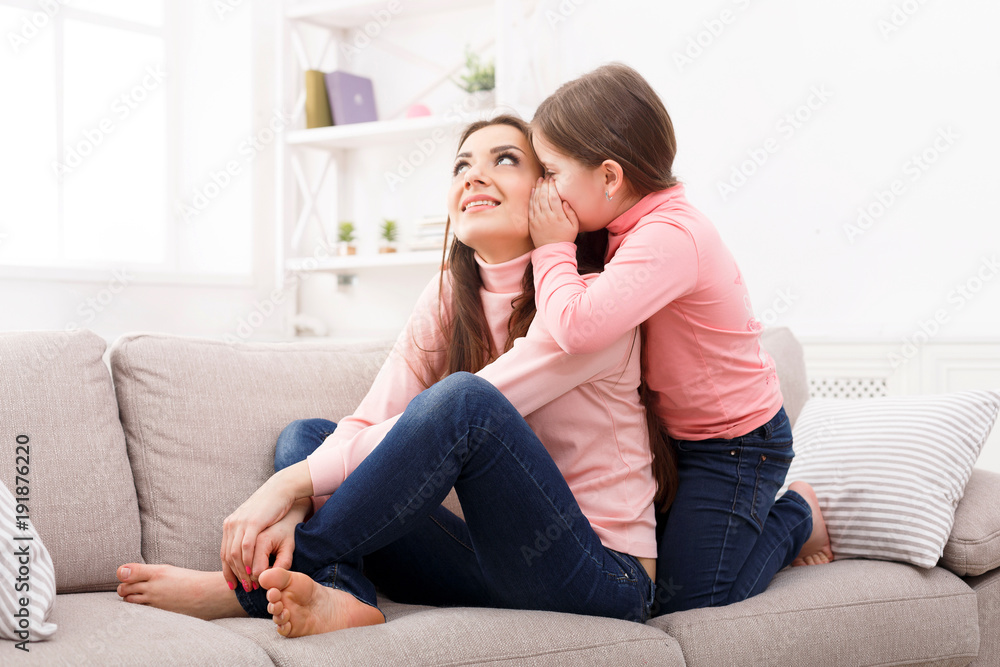 Mother with her cute little daughter sitting on the sofa. Mother with her cute little daughter sitting on the sofa.