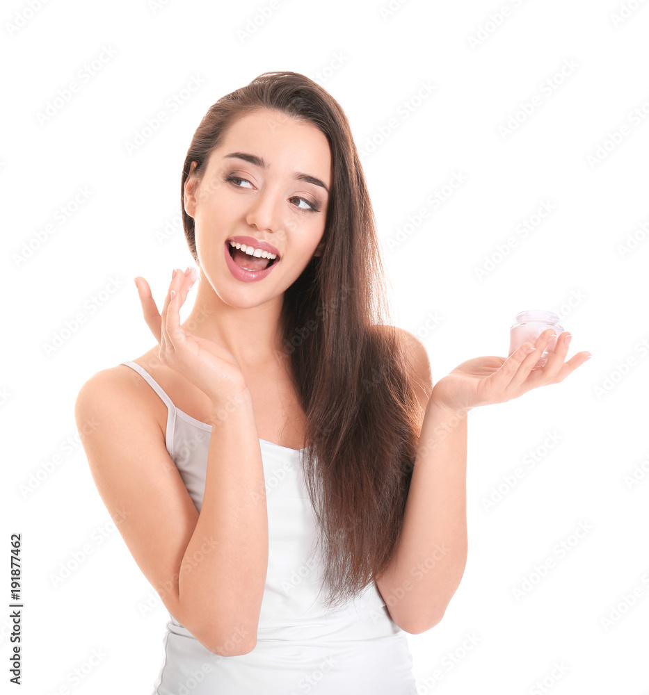 Young woman applying face cream on white background Young woman applying face cream on white background