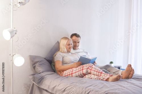 Senior couple reading book ...