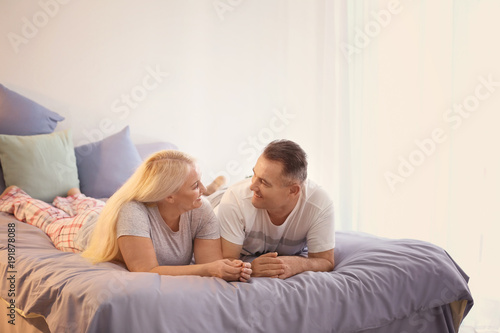 Senior couple on bed together