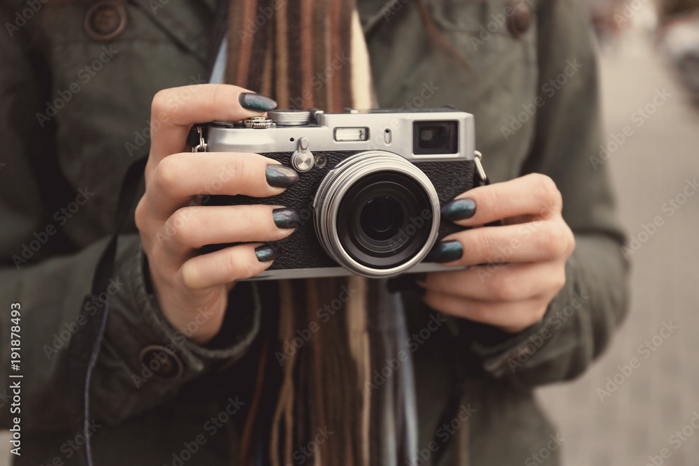 Young photographer with camera, outdoors Young photographer with camera, outdoors