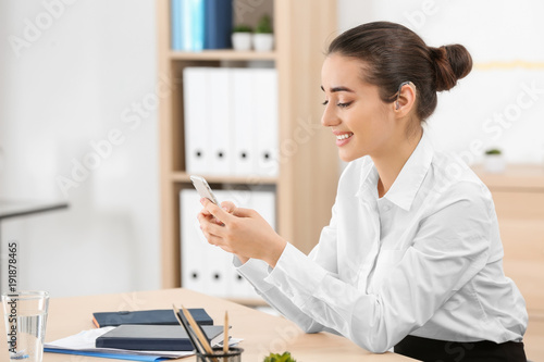 Young woman with hearing ai...