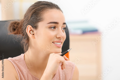 Young woman with hearing ai...