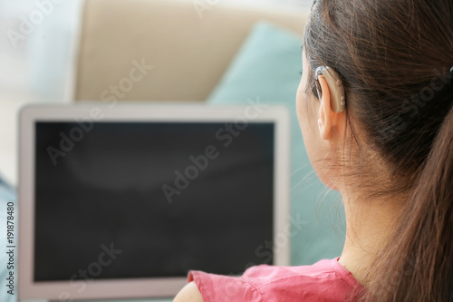 Young woman with hearing ai...