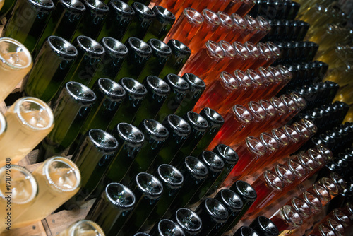 Sparkling wine bottles fermenting in winery