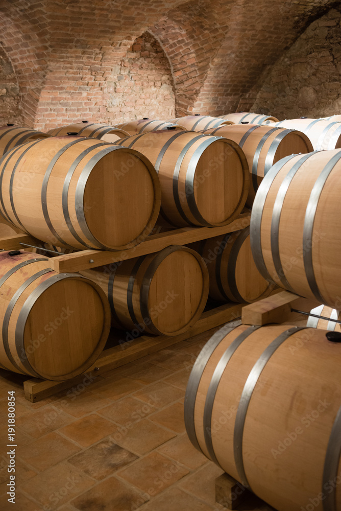 Wine barrels for storage in traditional cellar Wine barrels for storage in traditional cellar