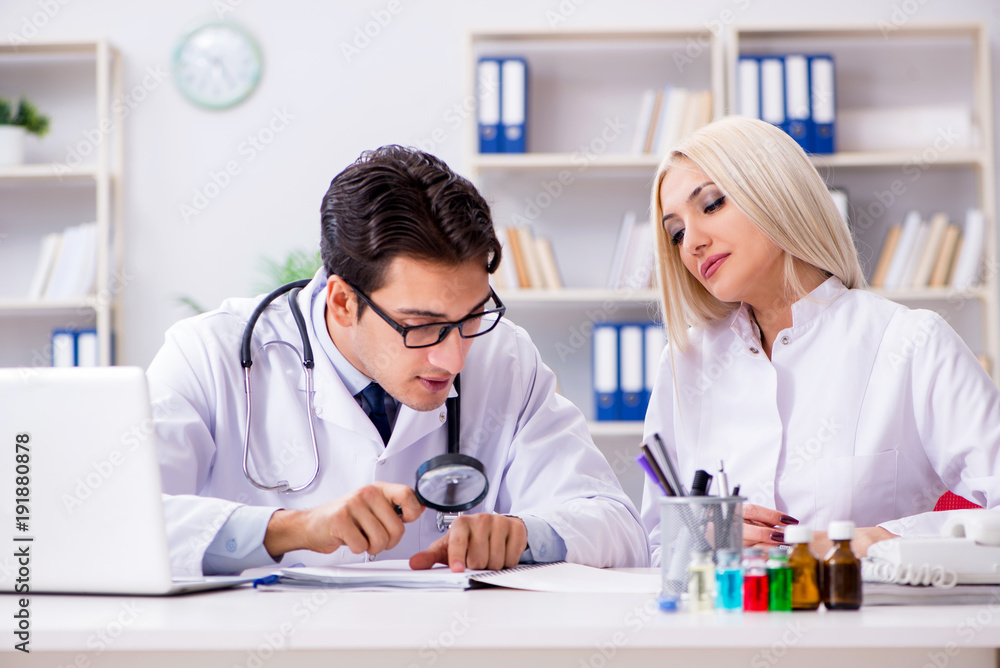 Male and female doctor having discussion in hospital Male and female doctor having discussion in hospital