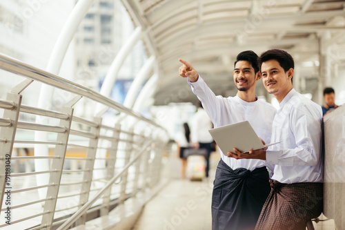 Myanmar peoples talking business in city using wireless technology
