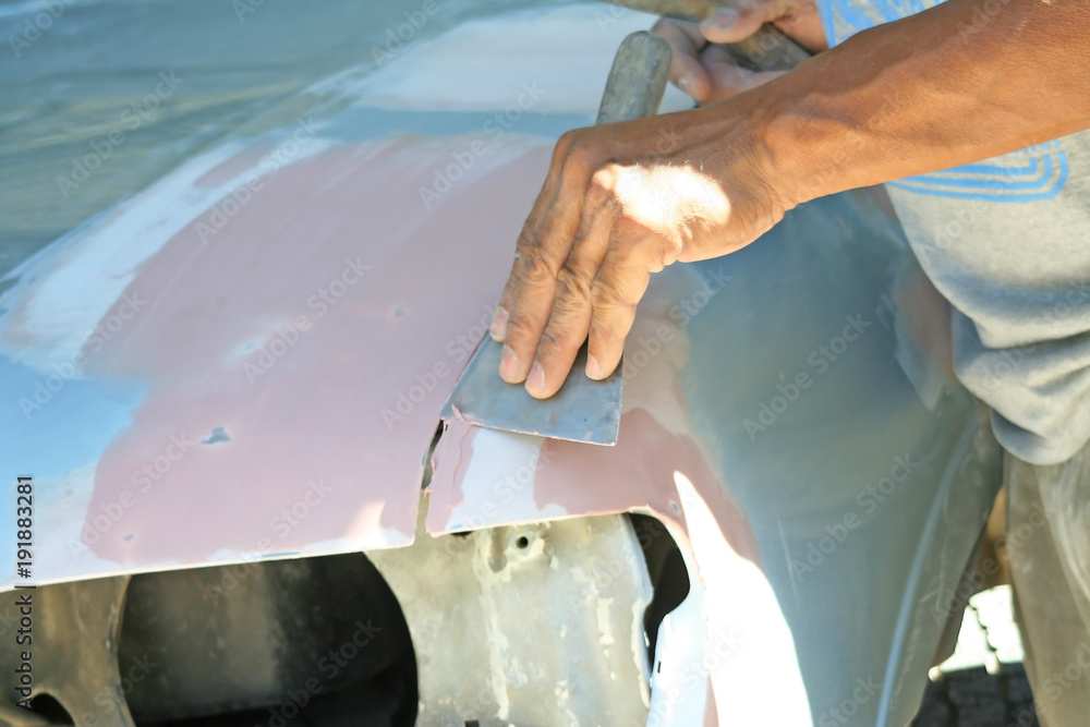 Automotive paint technician using paint on putty knife at , A