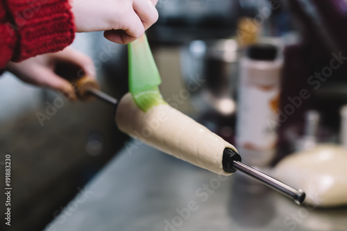 Cooking of trdelnik. Raw food in oven. Bakery pastry food