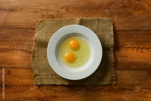 two egg yolks in the white plate