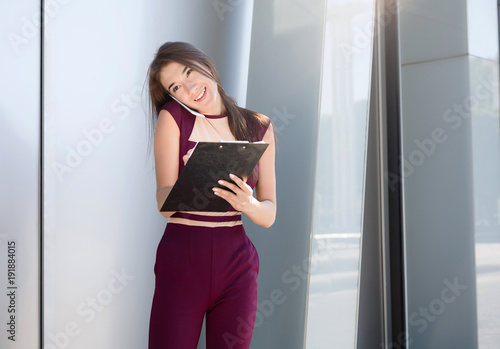 Businesswoman working with papers outdoors