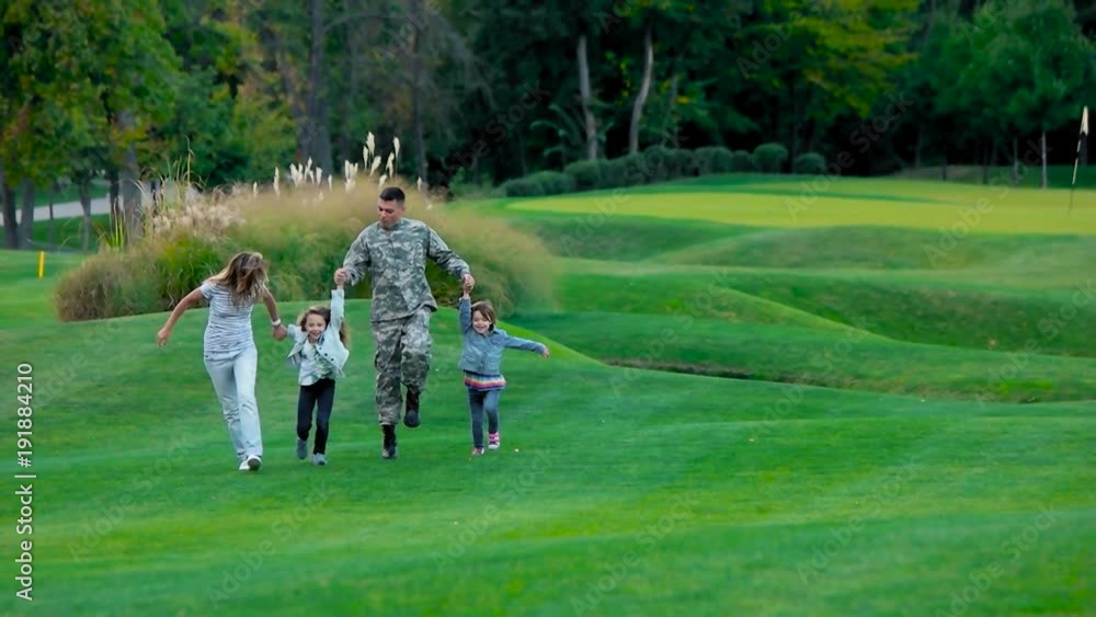 Front view military father with his happy familiy walking and jumping. American usa soldier at the facation with family, front view, slow motion. Front view military father with his happy familiy walking and jumping. American usa soldier at the facation with family, front view, slow motion.