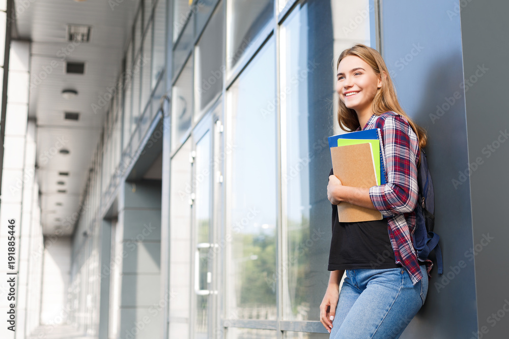 Student girl with books on university background Student girl with books on university background