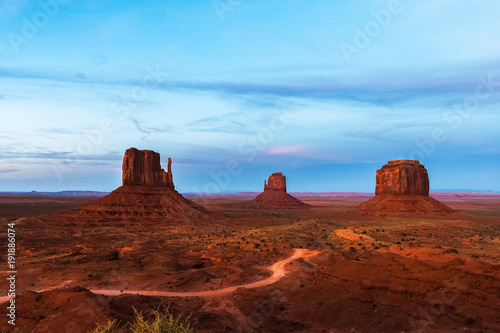 Fototapeta Naklejka Na Ścianę i Meble -  The West and East Mitten and the Merrick Buttes in Monument Valley Navajo Tribal Park at dusk, Arizona