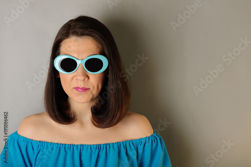 Woman in azure dress and sunglasses. © COLOR PHOTO