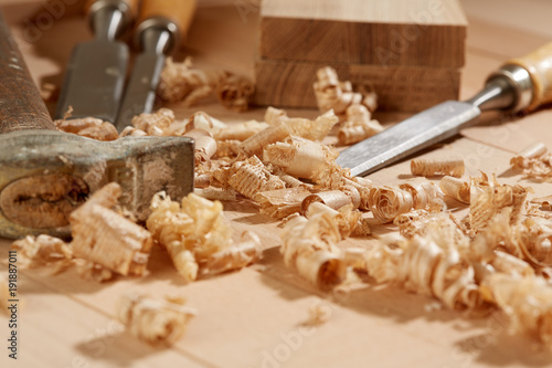 DIY concept. Woodworking and crafts tools. Carpentry hand tools on a workbench. Chisels, hammer, measuring tools. Wooden parts, planks and stocks. Wooden background.