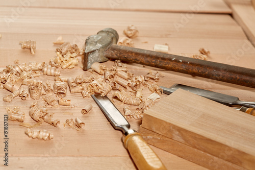 DIY concept. Woodworking and crafts tools. Carpentry hand tools on a workbench. Chisels, hammer, measuring tools.  Wooden parts, planks and stocks. Wooden background. photo