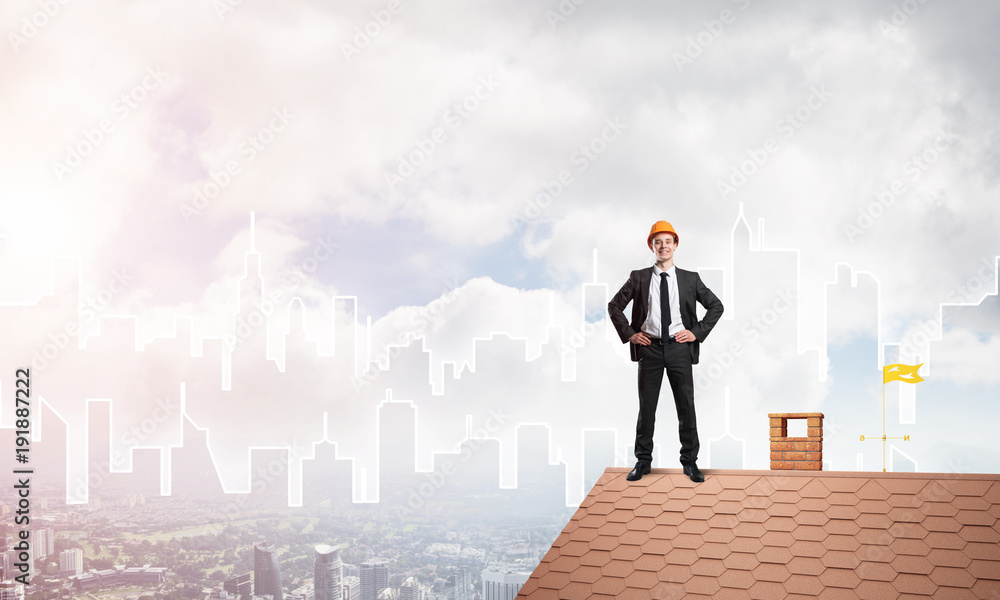 Engineer man standing on roof and looking away. Mixed media Engineer man standing on roof and looking away. Mixed media