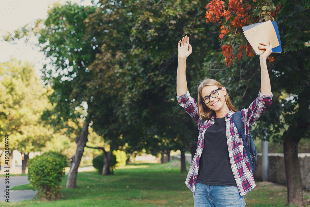 Student girl with books in park outdoors