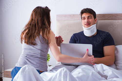 Loving wife taking care of injured husband in bed