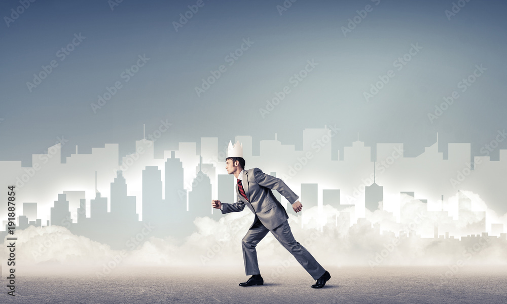 King businessman in elegant suit running and blue cityscape silh King businessman in elegant suit running and blue cityscape silh