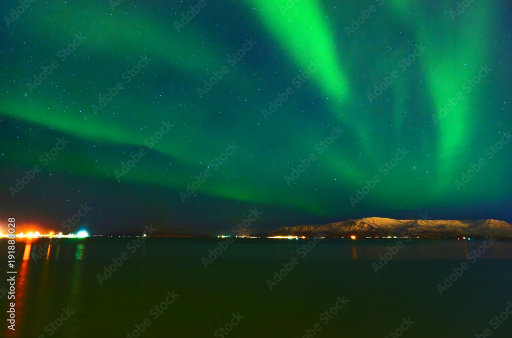 View of the northern light from the beachside in Reykjavik, Iceland.