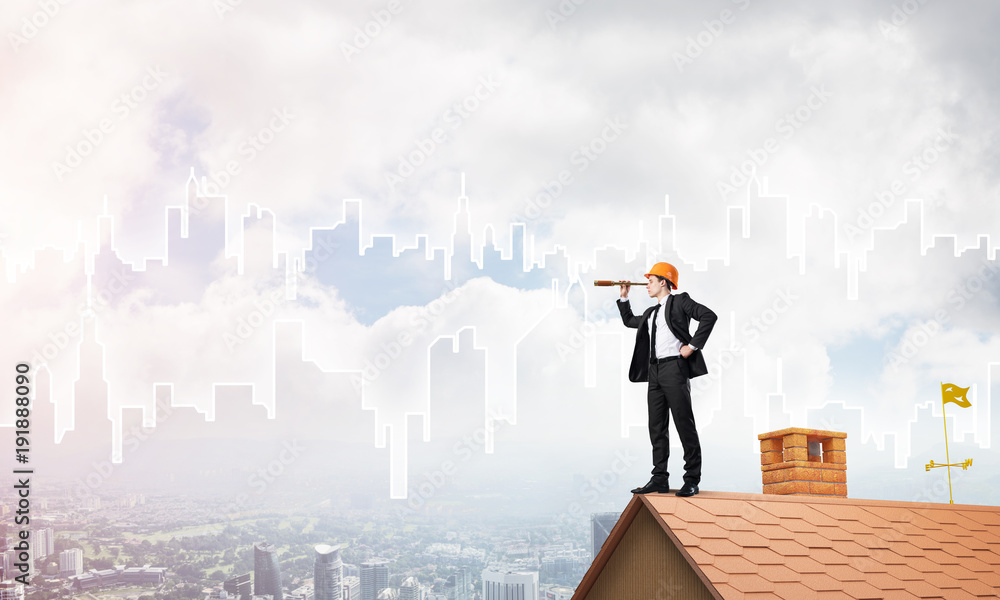 Engineer man standing on roof and looking in spyglass. Mixed media Engineer man standing on roof and looking in spyglass. Mixed media