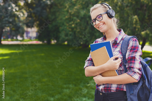 Student girl with books in park outdoors