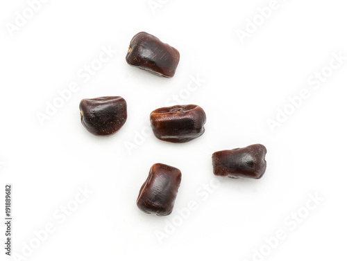 Five tamarind seeds top view isolated on white background Indian dates.