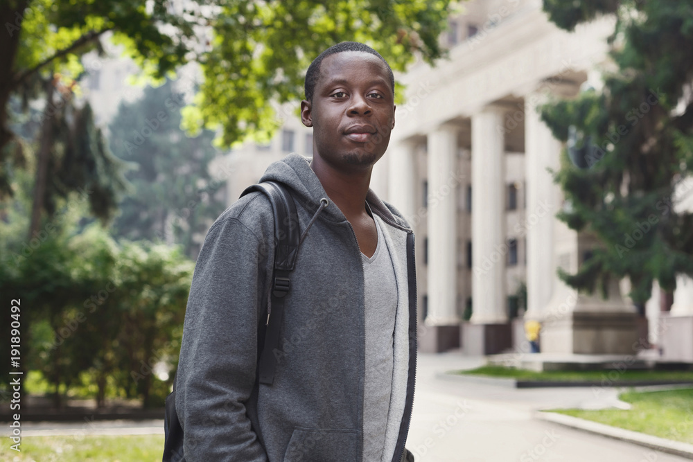 African-american student standing in university campus outdoors African-american student standing in university campus outdoors
