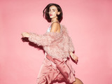 young fashion woman in pink clothes run on pink background