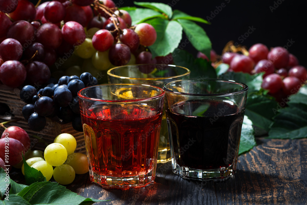 assortment of grape juice on wooden background, closeup assortment of grape juice on wooden background, closeup