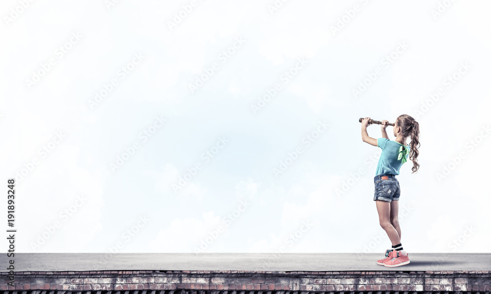 Concept of careless happy childhood with girl exploring this wor Concept of careless happy childhood with girl exploring this wor