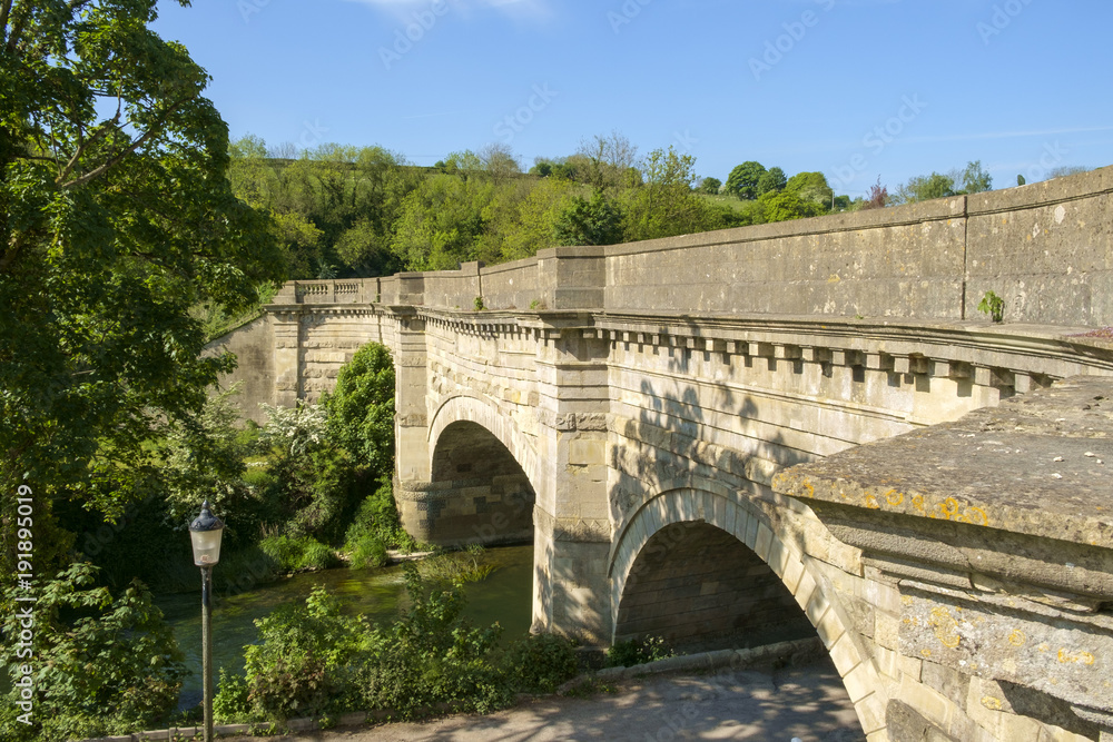 Fototapeta premium Historic Avoncliff Aqueduct carries the Kennet and Avon Canal over the River Avon and the Bath to Westbury railway line, at Avoncliff in Wiltshire, England