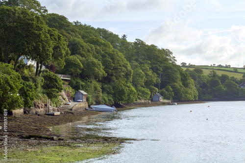 Peaceful early summer morning on picturesque boat moorings in the Helford Estuary at old fashioned Port Navas, Cornwall, UK photo