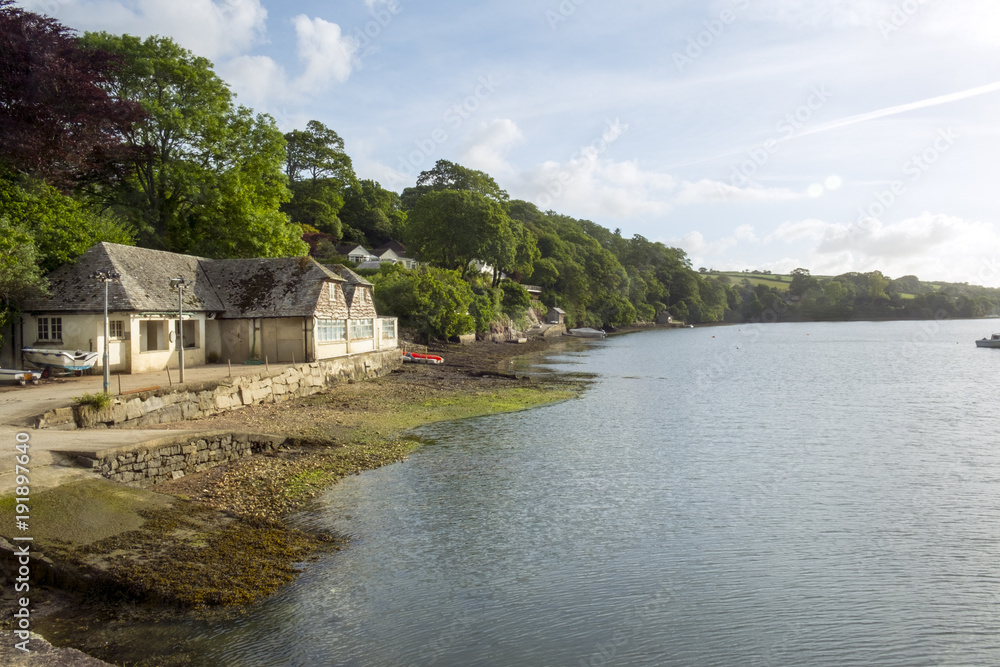 Peaceful early summer morning on picturesque boat moorings in the Helford Estuary at old fashioned Port Navas, Cornwall, UK