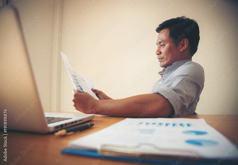 Fototapeta premium Businessman analyzing financial performance.