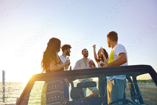 Group of happy friends making party in car - Young people having fun drinking champagne