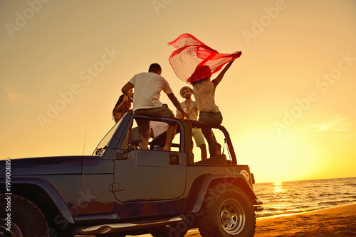 Canvas Print Group of happy friends making party in car - Young people having fun drinking ch