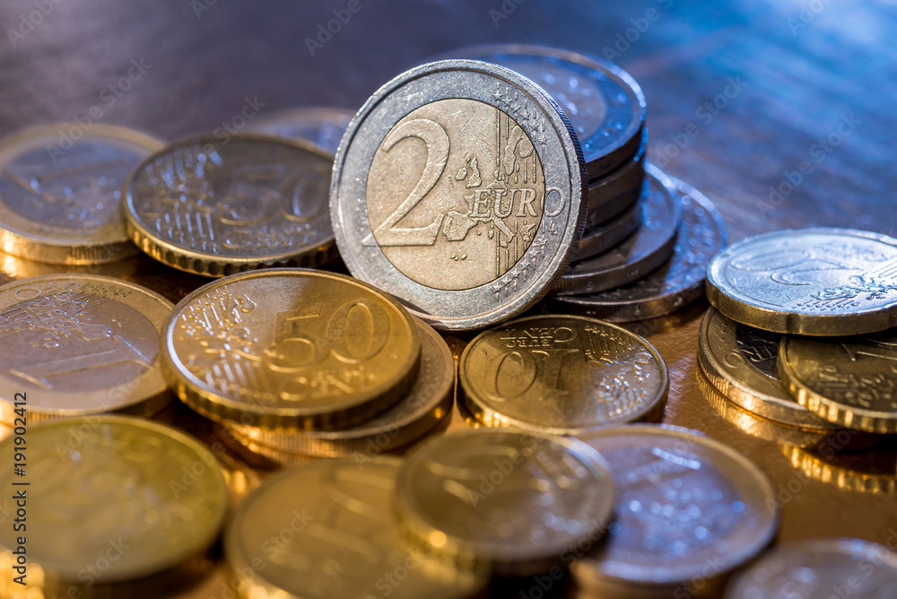 many euro coin isolated on gold close up many euro coin isolated on gold close up